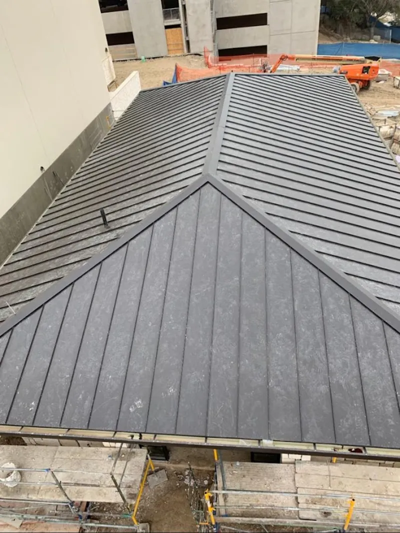 Commercial metal roof construction with crane equipment in Marlene Village